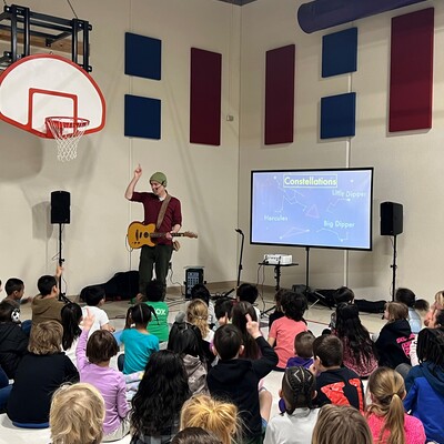 2024 Arts Infusion Artist, Dino O'Dell, performs for students at a USD 305 school.